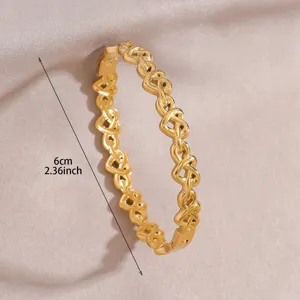 Gold stainless steel interlocking heart bracelet detail view showing fine craftsmanship.