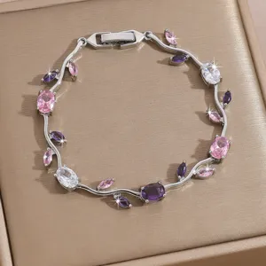 Elegant silver-tone crystal vine bracelet with sparkling pink and purple cubic zirconia stones.