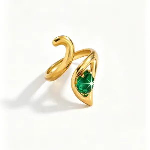 Close-up view of the polished gold stainless steel ring featuring a sparkling green zirconia detail.