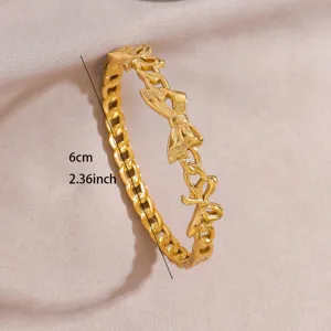 Gold plated stainless steel bow link open bracelet, fashion jewelry detail view for women.