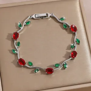 Detailed shot of a luxury zircon flower bracelet with red and green stones on silver chain.