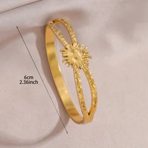 Gold stainless steel open bangle bracelet featuring a chic sun motif, elegant daily jewelry.