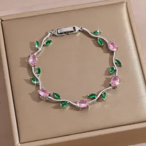 Exquisite zircon vine bracelet with pink oval and green leaf stones, detailed clasp.