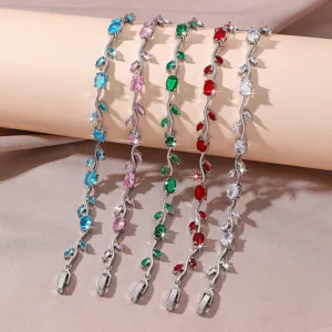 Detailed shot of sparkling colorful zircon branch bracelets, elegant floral vine jewelry design.