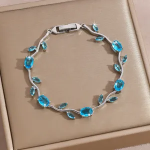 Silver-tone vine tennis bracelet featuring sparkling blue cubic zirconia leaf charms.