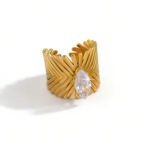 Gold plated stainless steel wide cuff ring featuring a marquise cut clear zircon stone