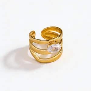 Detailed close-up shot of multi-band gold plated open ring with shiny oval cubic zirconia.