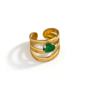 Close-up of a multi-layer gold plated stainless steel ring featuring a sparkling green zircon stone.