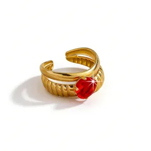 Gold plated stainless steel open ring with vibrant red zircon stone, stylish textured band jewelry.