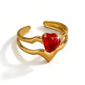Detailed close-up view of a gold-plated open ring featuring a red heart-shaped zircon.