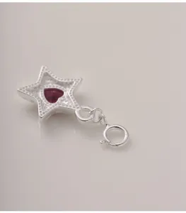 Detailaufnahme eines Sternanhängers aus 925er Sterlingsilber mit rotem Herz-Zirkon