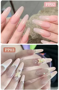 Macro shot of long almond nails featuring pink blush gradient and 3D floral pearl details
