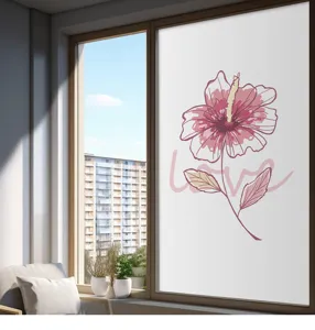 Detail view of frosted window privacy film featuring pink hibiscus flower design and LOVE text