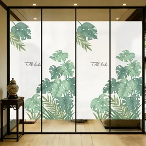 Fensterfolie Sichtschutz mit Aquarell Monstera-Blättern auf einer Glastür angebracht