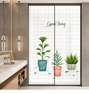 Detail view of frosted glass window film with green potted plant prints for home privacy protection.