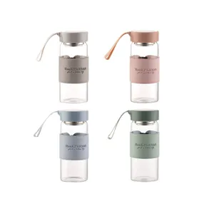 Portable glass water cup with leather sleeve and strap, clear borosilicate glass bottle.
