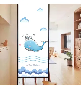 Detail of cartoon blue whale frosted privacy glass film on a window in a sunlit room
