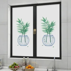 Detailed view of green bamboo leaf pattern privacy window film in a modern kitchen setting