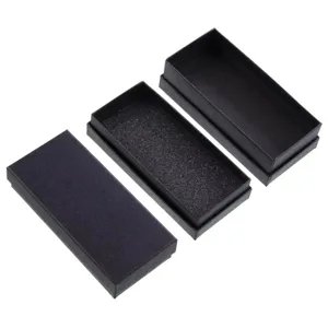 Detailed view of rectangular black watch boxes with textured finish and foam inserts