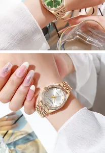 Elegant detail of a gold-tone ladies quartz watch with a rhinestone bezel on a wrist