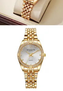 Macro detail of luxury gold women's watch with rhinestone bezel and five-link strap