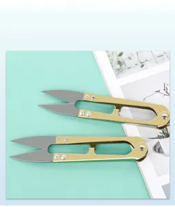Golden U-shaped thread scissors detail, spring design for easy yarn and cross-stitch trimming.