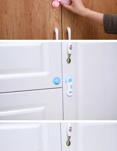 Detailopname van kinderveiligheidsslot geïnstalleerd op kastdeuren, boorvrij ontwerp.
