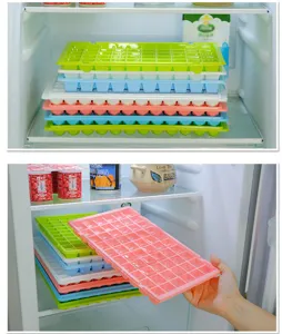 Detailed view of stackable multi-layer ice cube trays inside refrigerator storage.