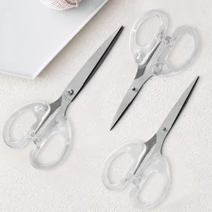 Detailed close-up view of transparent handle stainless steel craft scissors for student DIY.