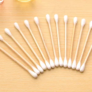 Detailed closeup view of disposable wooden cotton swabs neatly fanned out on a table surface
