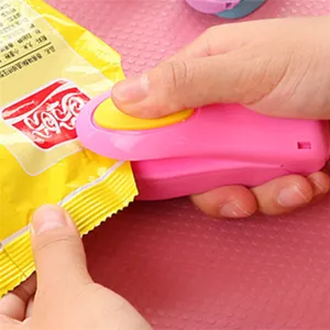 Mini portable heat sealer for plastic bags, handy snack bag sealing machine in pink.