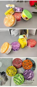 Solid air freshener detail showing various colorful scented cans for home and car use.