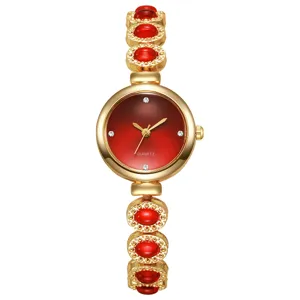 Montre bracelet de luxe pour femme en or avec pierres rouges et cadran dégradé