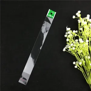 Transparent straw cleaning brush packaging bag with green hanging card for narrow tubes.