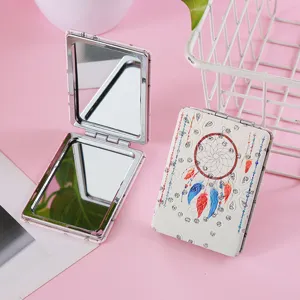 Close up of portable double sided folding makeup mirror with dreamcatcher and crystal rhinestones.
