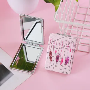 Portable double-sided folding makeup mirror with pink pu leather, rhinestones and feathers.