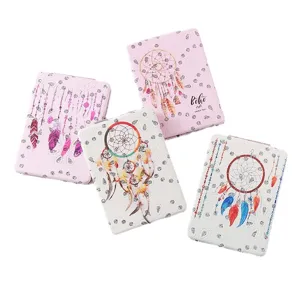 Portable folding makeup mirror with rhinestone boho dreamcatcher design for travel use.