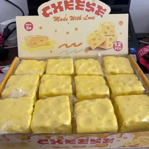 Detailed view of the yellow cheese squeeze toy set in packaging box, soft slow rebound.