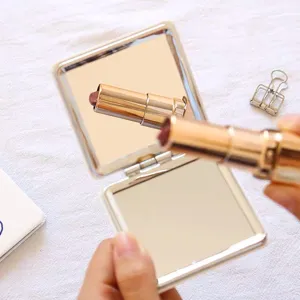 Portable compact folding double-sided makeup mirror, perfect for daily touch-ups and travel.