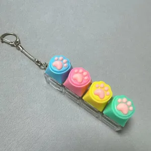 Close-up detail of colorful silicone cat paw keycap keychain mechanical switch fidget toy.