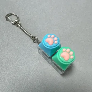 Cute cat paw decompression keycap keychain with dual transparent switch tester for fun stress relief.