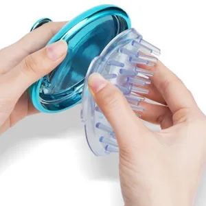 Detail showing the detachable soft silicone brush head of the blue scalp massager