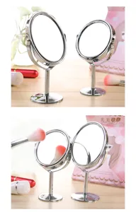 Detail view of the double sided desktop makeup mirror featuring a glossy metal rotating frame.