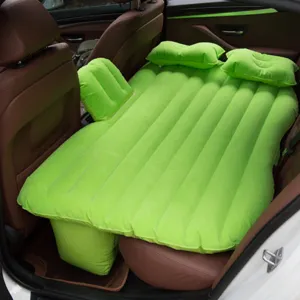 Car inflatable mattress detail showing rear seat installation with green flocking surface and pillows.