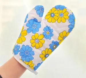 Detailed view of kitchen oven mitt featuring blue and yellow floral pattern heat resistant fabric.
