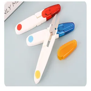 Detailed shot of portable U-shaped thread scissors with colorful protective caps for sewing.