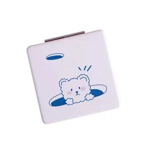 Portable folding makeup mirror with cute cartoon bear print, double-sided pocket cosmetic mirror.