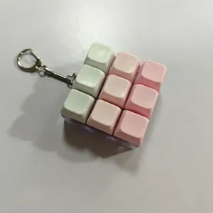 Detailed view of the mechanical keyboard keycap fidget toy keychain with cute pastel colors.