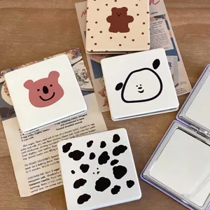 Portable folding makeup mirror with cute cartoon animal patterns for daily use desktop.