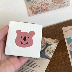 Portable folding makeup mirror with cute pink bear design for daily travel and desk use